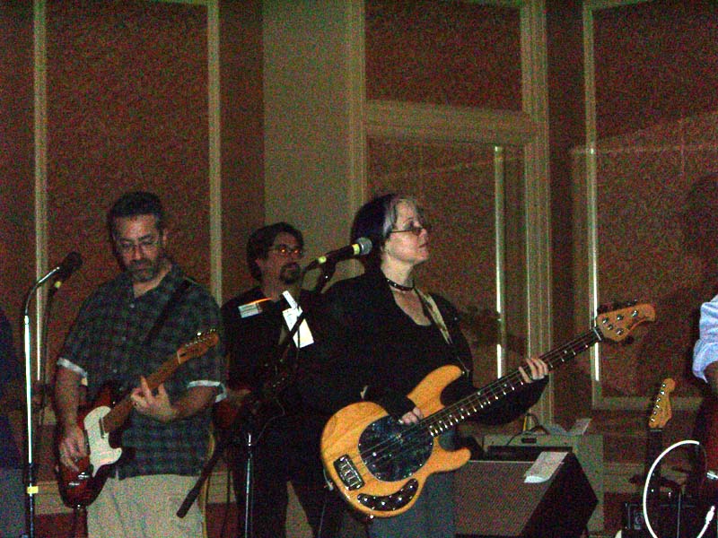 Caroline Spector plays guitar in a band at the ArmadilloCon dance. Austin, TX 2005
