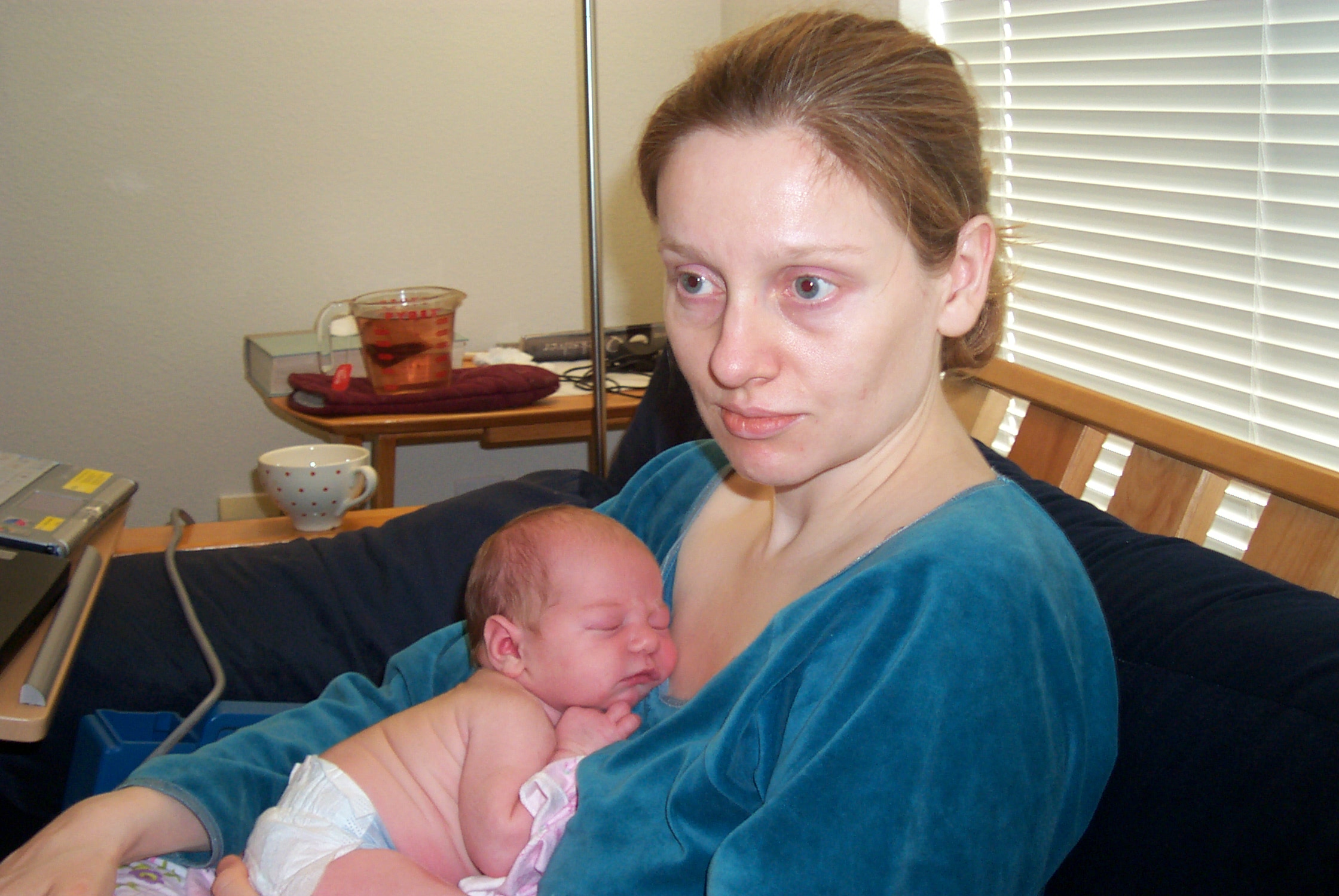 First week: I'm holding E in those first bleary days of new motherhood. May 2005