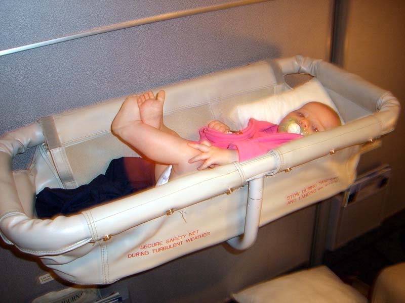 On the plane in a bassinet, August 2005
