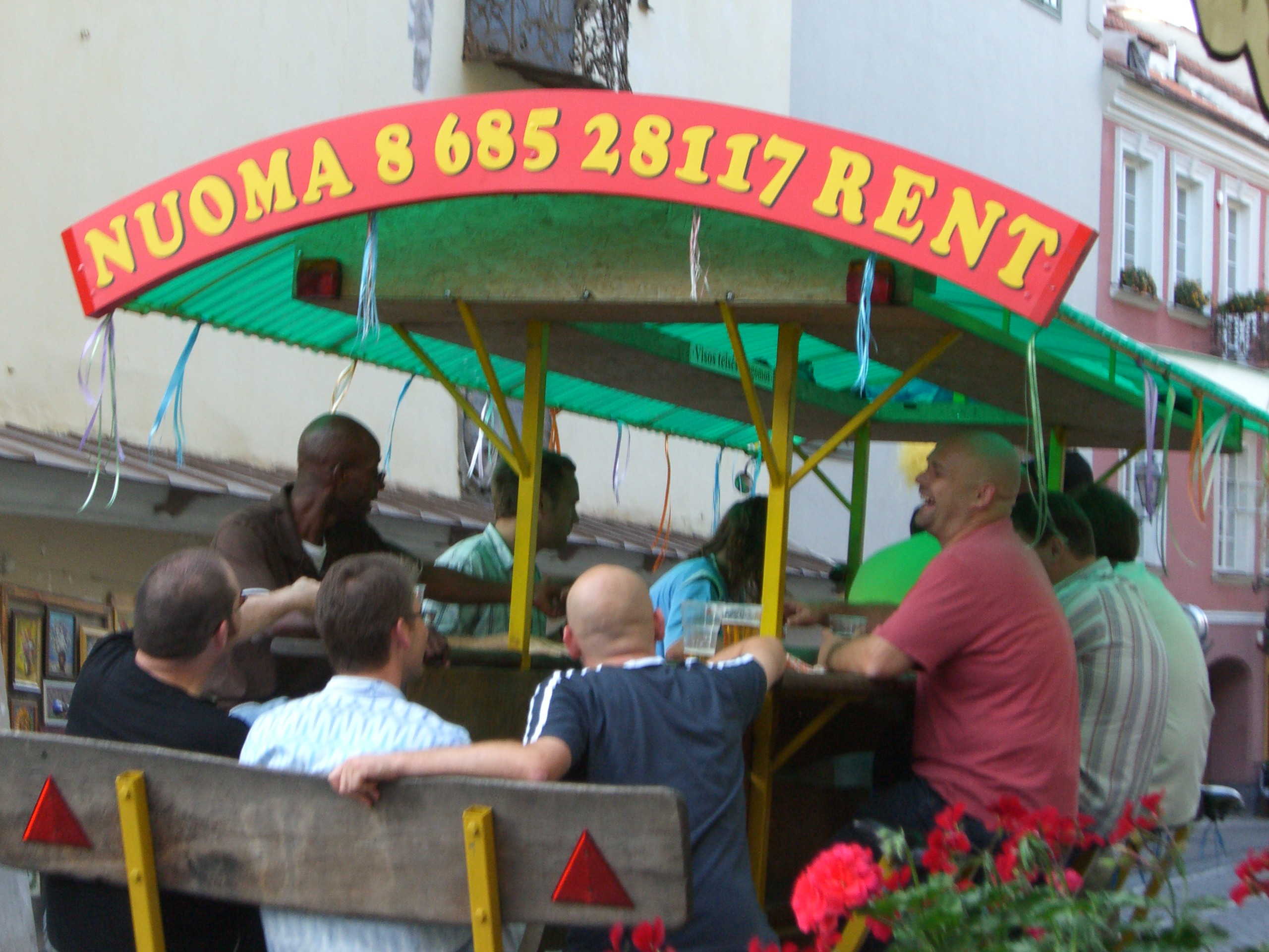 A bar on wheels drives down the street in Vilnius Old Town in September 2005