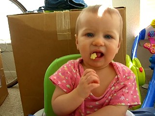 Trying to eat a corn puff, February 2006