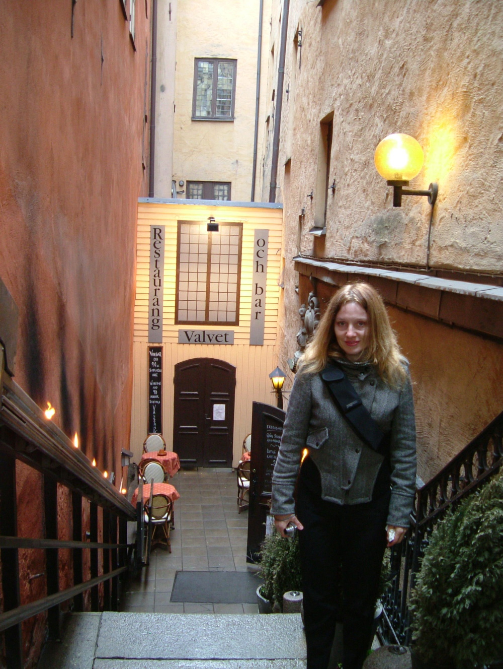 Me in an alley of stairs, leading to restaurant at the basement level in Stockholm Old Town