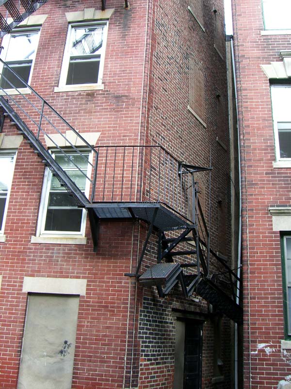 A fire escape wrapping around the corner of a house