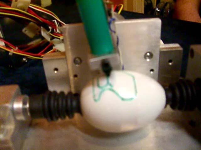 A robot draws on an egg