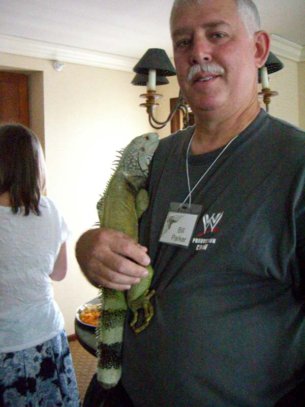 A con-goer with an iguana on his shoulder