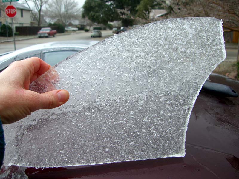 Hand holds a sheet of ice