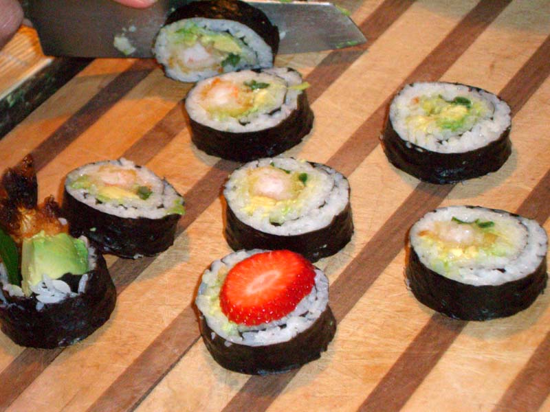 Sushi made with various combinations of crab, avocado, and strawberry