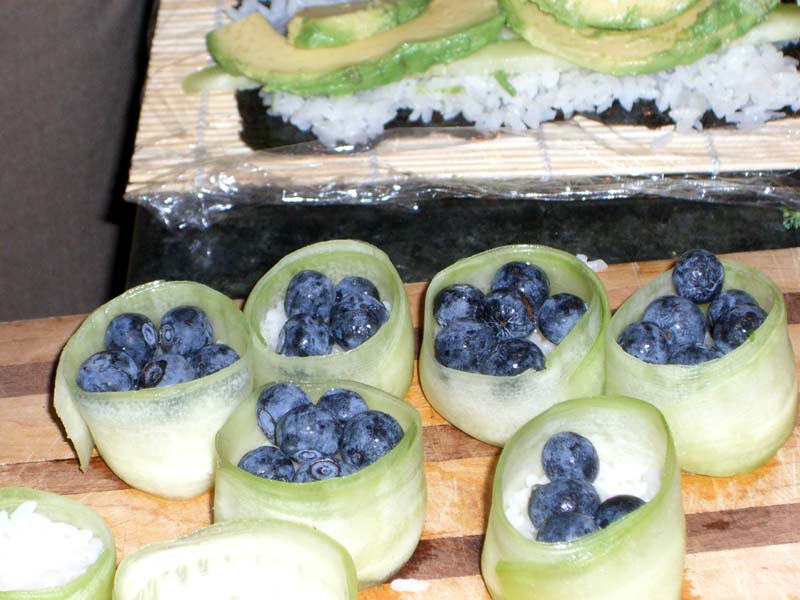 Cucumber sushi wrapper filled with rice and blueberries