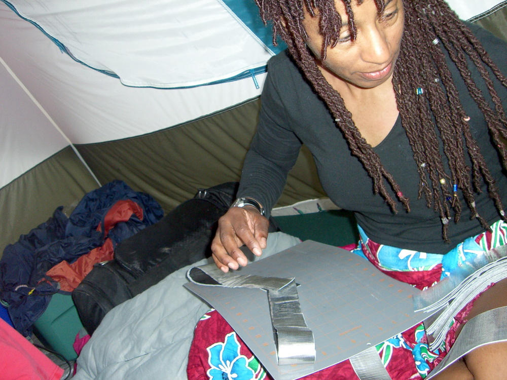 M in the tent, making a costume for the burn
