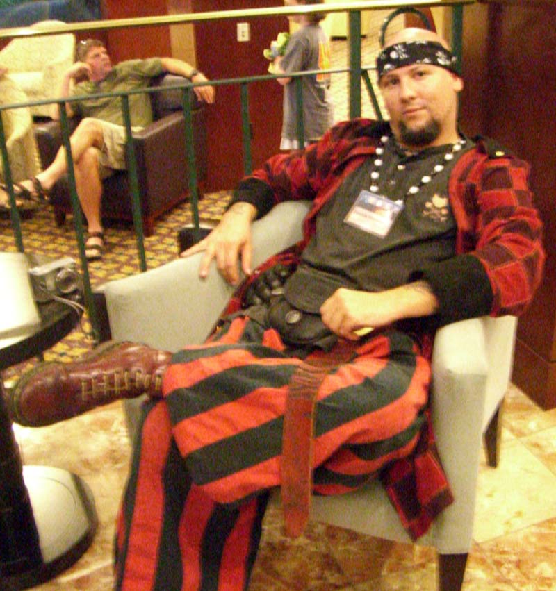 A congoer in red and black striped and checkered costume at ApolloCon 2007