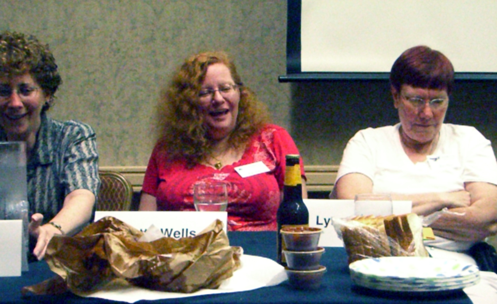 Con disaster stories panelists, left to right, Janice Gelb, Patty Wells, and Lynn Ward, behind the barbewue leftovers