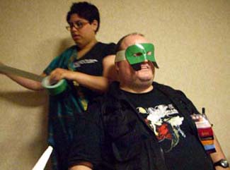 Val with a roll of tape, making Chuck's mask