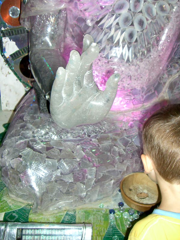A closeup of the hand of the Buddha-robot.