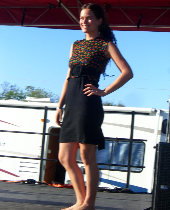 A black dress with a red-and-green floral print top from Swap-o-Rama-Rama fashion show from Maker Faire 2007, made of recycled materials