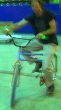 A person trying to ride a bicycle with a hinge in the middle