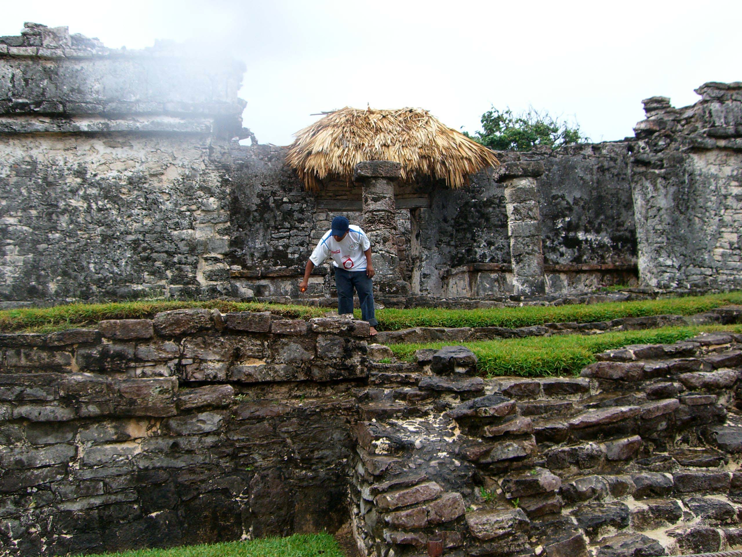 A building with a thatched roof in the Mayan ruins of Tulum