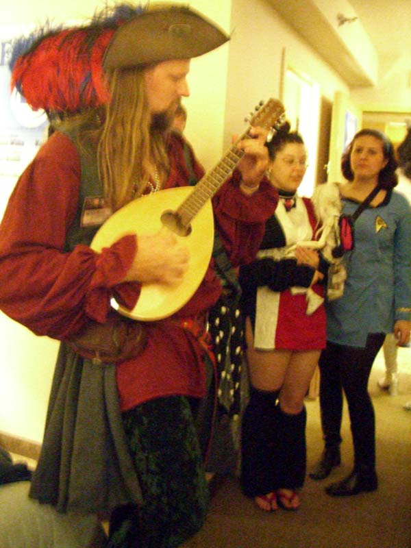 Congoer plays a stringed instrument at ApolloCon 2007 room party