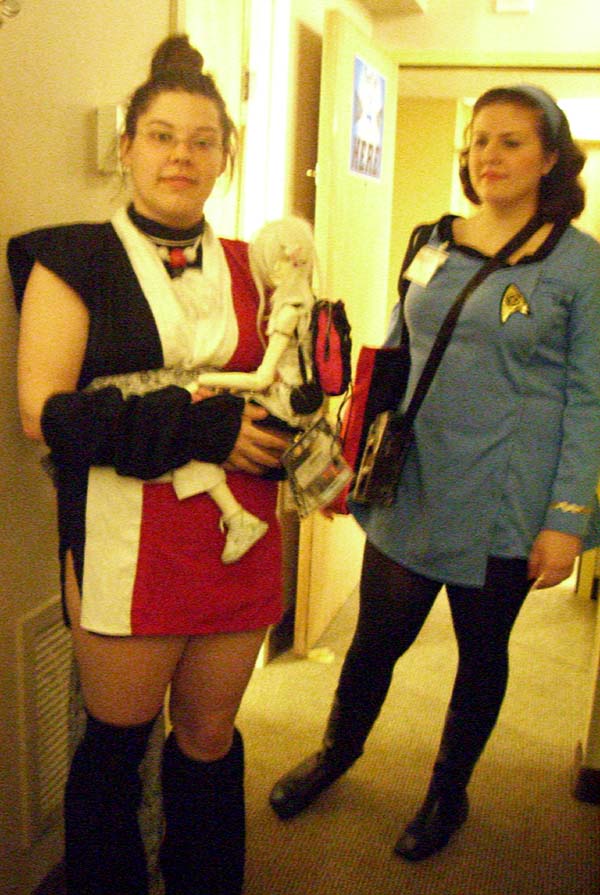 A congoer dressed as a manga character, and Katie in a Star Trek uniform