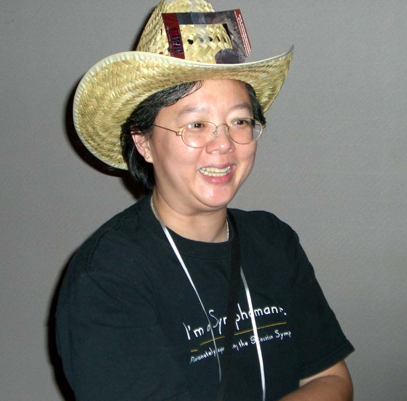 A person in a cowboy hat with musical notes on it, named Ann
