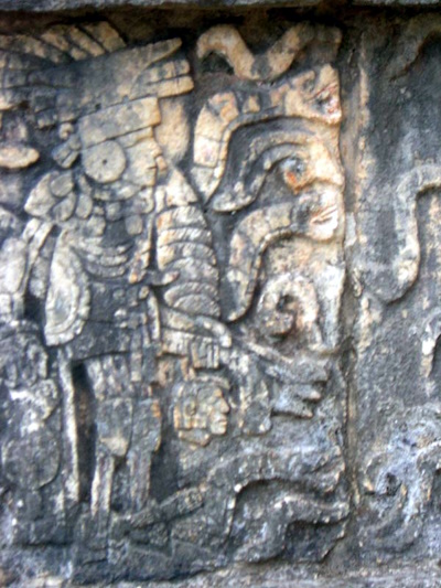 Priest holds a severed head - a Mayan carving in Chichen Itza